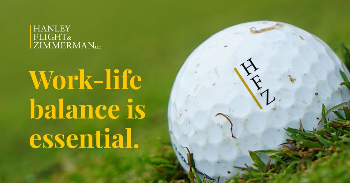 golf ball with hanley flight & zimmerman logo with text that states work life balance is essential